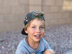 Green camo toddler and kids size snapback baseball cap with flat brim and faux leather logo patch
