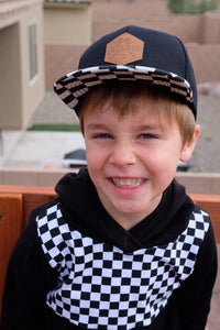 Checkered toddler and kids size snapback baseball cap with flat brim and faux leather logo patch
