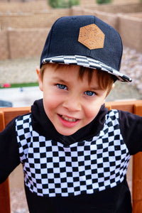 Checkered toddler and kids size snapback baseball cap with flat brim and faux leather logo patch